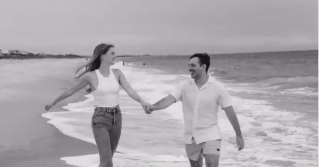beach couple poses holding hands