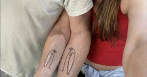 arm penguin couple tattoo