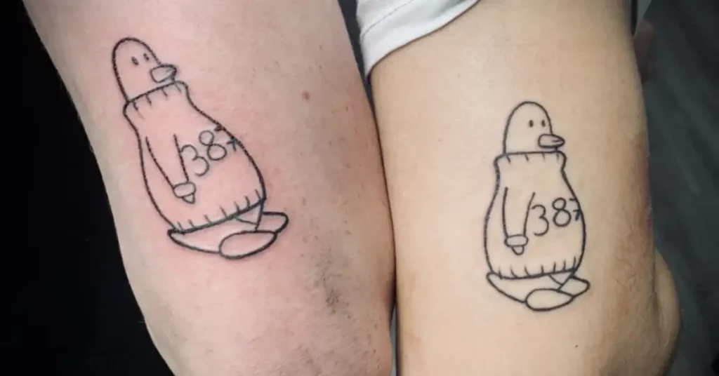 funny looking penguin couple tattoo