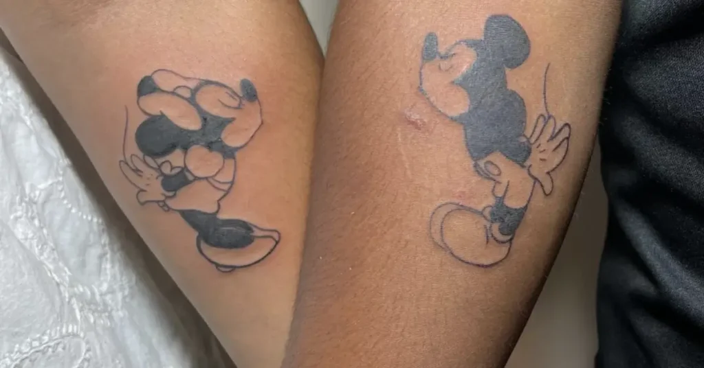 kissing micky mouse disney couple tattoos